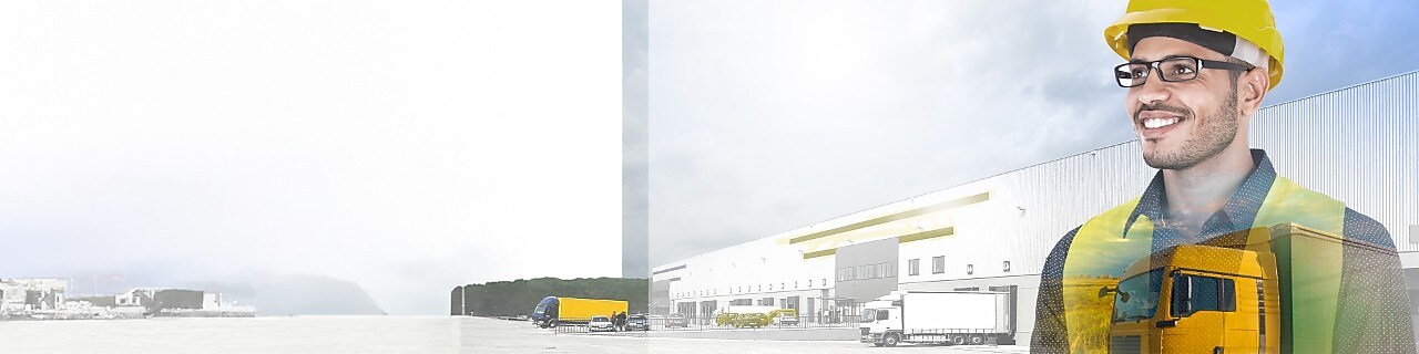 A white truck driving down a road at dusk