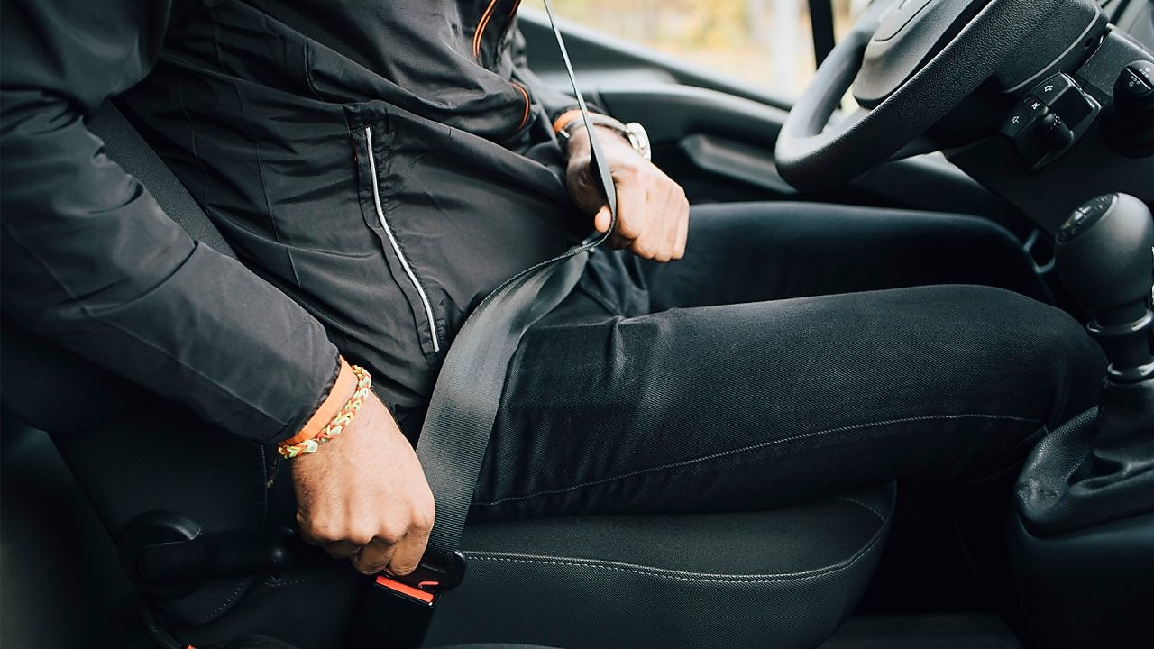 Personne attachant leur ceinture de sécurité